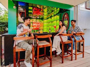 a group of people sitting at a bar at The Hosteller Goa, Anjuna in Arpora