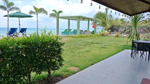 a patio with a table and chairs and the ocean at Lipa Bay Residence in Nathon Bay
