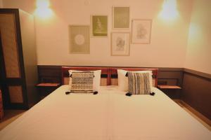 a bed with two pillows on it in a room at Hotel Gargo Tower in Guwahati +3 photos