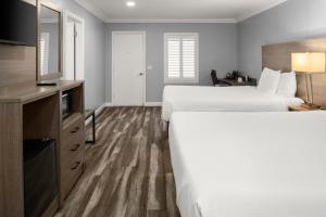 a hotel room with two beds and a television at Lone Oak Lodge in Monterey +32 photos