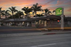 a fast food restaurant with a sign on the street at Lone Oak Lodge in Monterey