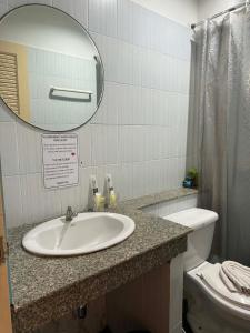 a bathroom with a sink and a mirror and a toilet at Flowernight Guesthouse in Kata Beach +30 photos