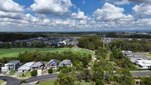 an aerial view of a residential neighbourhood with a golf course at Golf Course Frontage House in Schofields +7 photos
