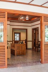 a living room with a bed and a mirror at Summit resort in Balangoda