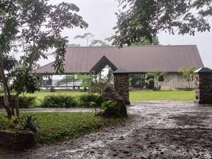 a stone building with a metal roof on a field at Summit resort in Balangoda +5 photos