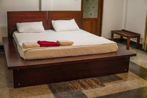 a bed with two towels sitting on top of it at Summit resort in Balangoda