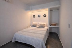 a bedroom with a bed with two mirrors on the wall at Downtown, Comfortable Loft, in Hermosillo
