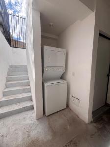 an empty room with a staircase with a refrigerator at Downtown, Comfortable Loft, in Hermosillo