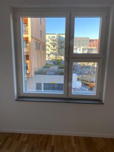 a room with a window with a view of a city at Nice flat in Barkarby in Järfälla