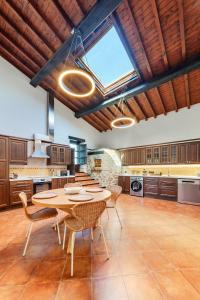 a large kitchen with a table and chairs at La Quintana de Los Valles in Benia de Onís