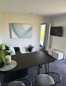 a living room with a black table and chairs at Swansea Cabins in Swansea