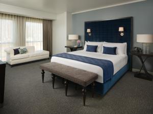 a large bedroom with a large bed and a couch at The Fontaine in Kansas City +53 photos