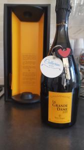 a bottle of wine sitting on a table next to a box at Catherine Suite in SantʼEufemia Lamezia