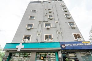a building with a cross on the side of it at Hotel Prestige Grand, Manikonda in Haidar Sāhibgūda