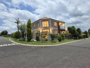 a large house on the side of a street at XLA Home Guest house in eMalahleni