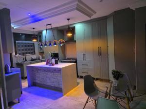 a kitchen with a island in the middle of a room at XLA Home Guest house in eMalahleni