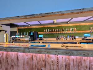 a bar at a restaurant with a wooden counter at 141 -Two bed Chalet on Sunbeach Holiday Park - Sleeps 6, pet friendly, FREE pool and entertainment passes included - plus WiFi with bedding and towels included - only 300m from the beach! in Scratby