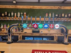 a bar with a bunch of bottles of beer at 121 Sunbeach - Two bed Chalet at Scratby - Sleeps 5, pet friendly - plus WiFi, bed linen and towels included - FREE swimming passes and Entertainment - Only 300m from the beach in Scratby