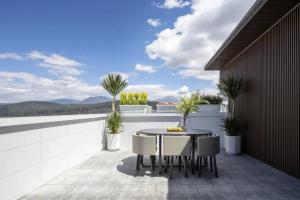 a patio with a table and chairs on a balcony at 雲幔宋居 in Lijiang