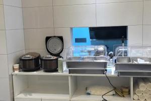 a shelf in a kitchen with some items on it at 雲幔宋居 in Lijiang +32 photos
