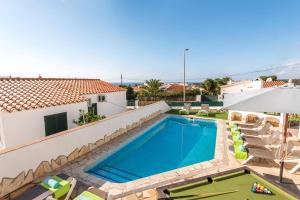a swimming pool on the roof of a house at Villa Santi I by Villa Plus in Cala en Porter