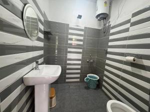 a small bathroom with a sink and a mirror at West corner B Homestay in Mawlynnong