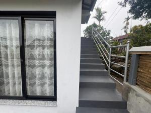 a staircase leading up to a house with a window at West corner B Homestay in Mawlynnong