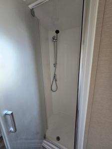 a shower in the corner of a bathroom at Palm trees and the sea in Reighton +43 photos