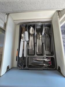 a drawer filled with utensils in a refrigerator at Palm trees and the sea in Reighton