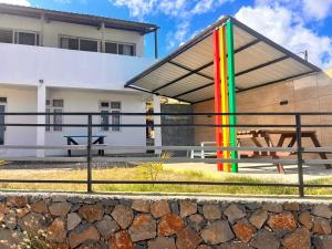 a building with a picnic table in front of it at EcoDream Lodge in Abercrombie