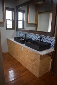 a bathroom counter with two sinks and a mirror at 118 Terrace in Nakijin +51 photos