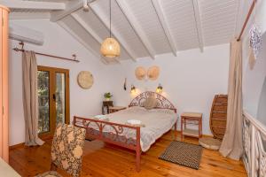 a bedroom with a bed in a room at Astrelis Emerald Villa - Cozy House Walking Distance to the Beach in Kalyves