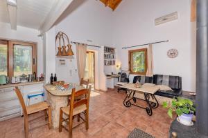 a kitchen with a table and chairs in a room at Astrelis Emerald Villa - Cozy House Walking Distance to the Beach in Kalyves