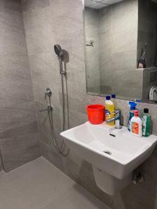 a bathroom with a white sink and a shower at Stayverse noida in Greater Noida