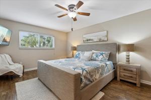 a bedroom with a bed and a ceiling fan at 10 Colonial Drive in Cocoa Beach