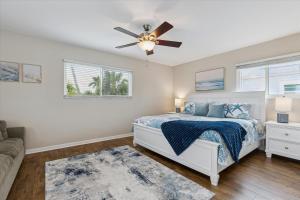 a bedroom with a bed and a ceiling fan at 10 Colonial Drive in Cocoa Beach +42 photos