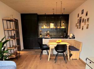 a kitchen with a table and chairs and a counter at "Unter Freunden", Design Meets Allgäu in Wertach