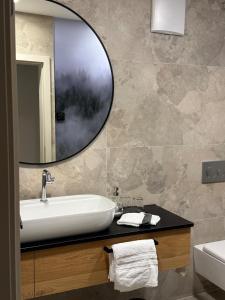 a bathroom with a sink and a mirror at "Unter Freunden", Design Meets Allgäu in Wertach