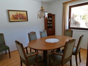 a dining room with a wooden table and chairs at Gästehaus Gruber in Pusterwald +3 photos