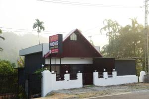 a fast food restaurant with a black building at Cloud valley wayanad in Vayittiri +9 photos