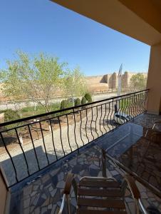 a balcony with chairs and a railing with a view at Hotel Asia Khiva in Khiva
