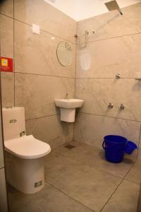 a bathroom with a toilet and a sink at Cloud valley wayanad in Vayittiri
