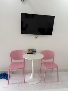 a table and two chairs with a table and a tv at The Moon Hotel in Chánh Long +18 photos