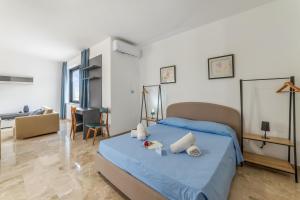 a bedroom with a bed and a living room at Tenuta VillaMar Rooms in Cursi
