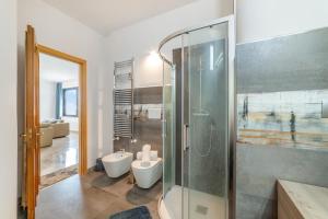 a bathroom with a glass shower and a toilet at Tenuta VillaMar Rooms in Cursi +33 photos