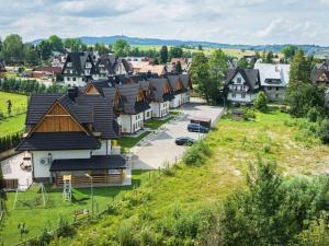 an aerial view of a village with houses at Golden Apartments - Tatra View - Księżycowe Apartamenty SPA - 24d-1 in Zakopane