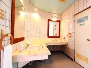 a bathroom with two sinks and a mirror at Garden BBQ and Stay ANCHOR in Miyakojima +24 photos