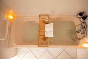 a bath tub in a bathroom with a book at Casa Dina - in Chalon-sur-Saône +91 photos