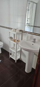 a white bathroom with a sink and a mirror at LURRA Tierra Apartamento 1 in Sopuerta