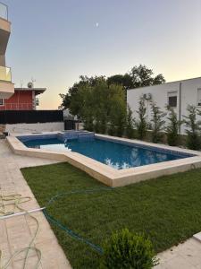 a swimming pool in the middle of a yard at Villa Mr Richard in Sutomore
